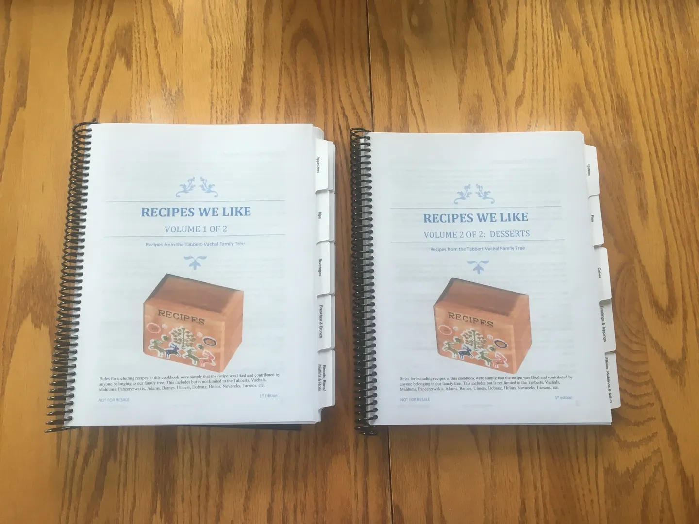 Two spiral bound recipe books on a table.