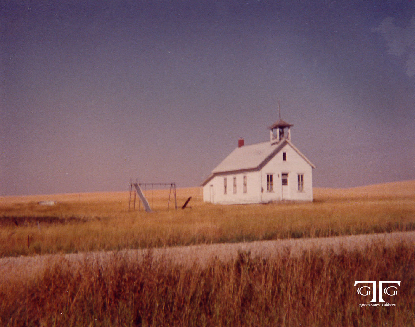 A white church with red roof in the middle of nowhere.
