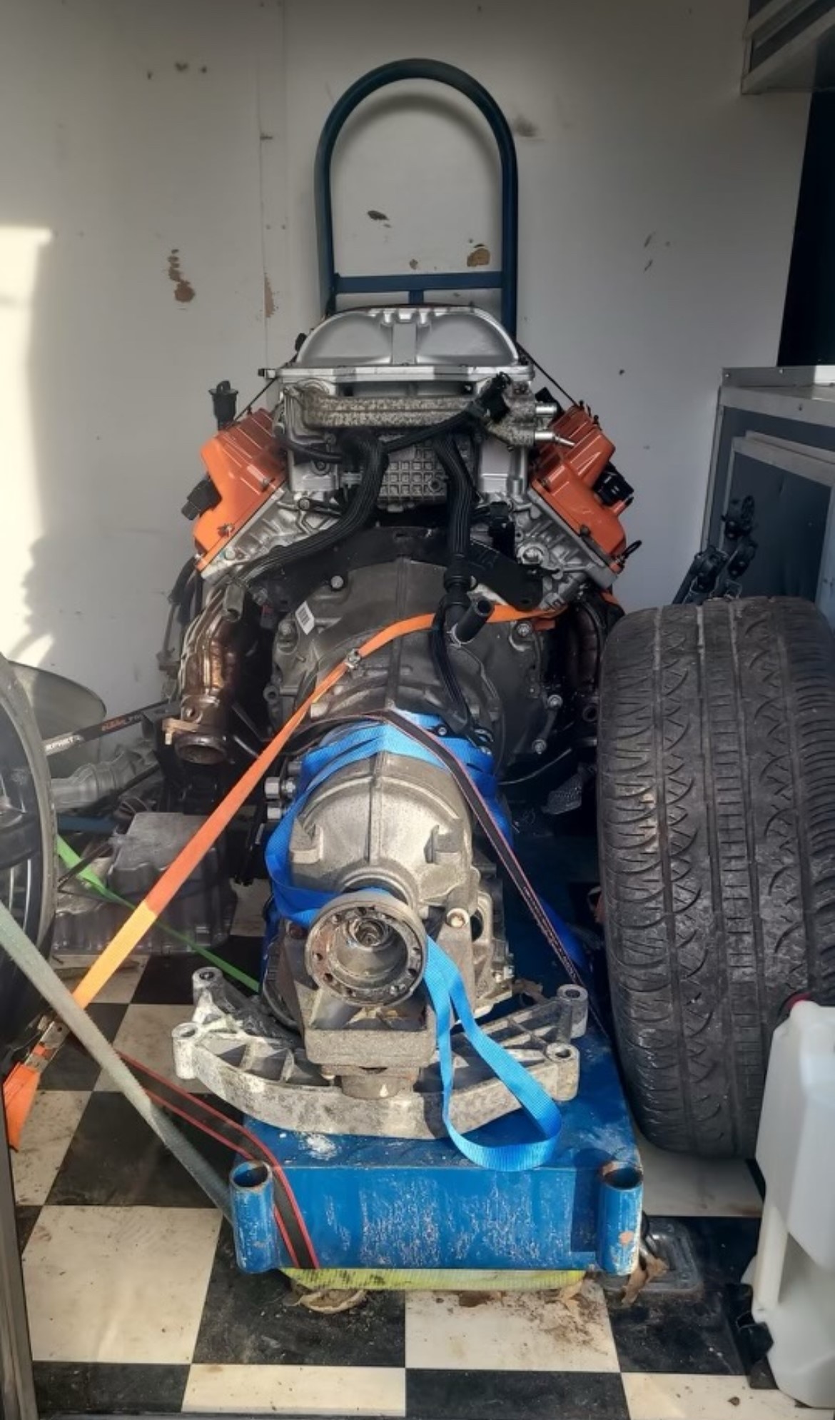 A car that is being worked on by someone.