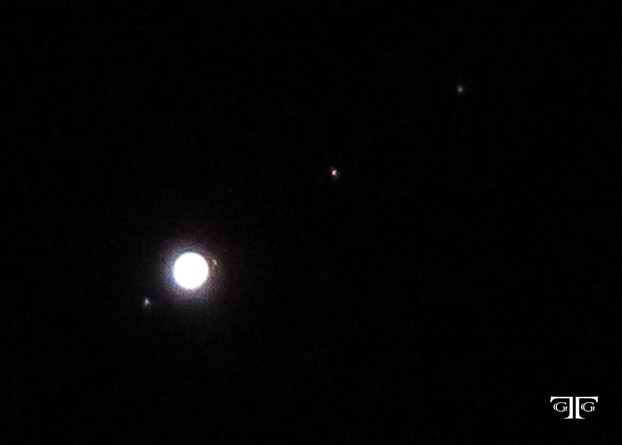 A full moon with jupiter and saturn in the background.
